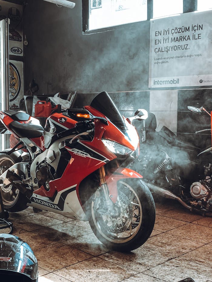 Vibrant red Honda motorcycle in a showroom, showcasing sleek design and power.